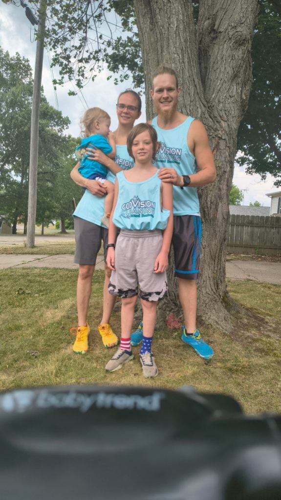 Elijah and Kylie of Godvision Cleaning with their children, all in Godvision Cleaning shirts, in Battle Creek, Michigan
